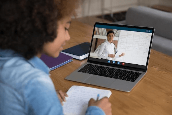 Tutor helping a student learn online